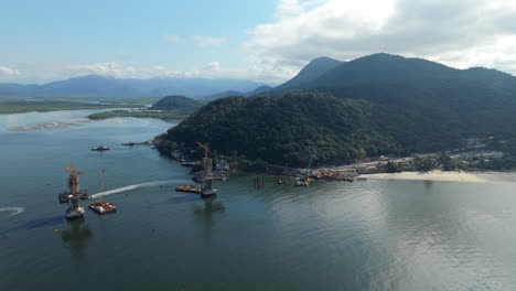 approaching aerial movement to the new guaratuba-matinhos bridge's construction area and port, paraná, brazil