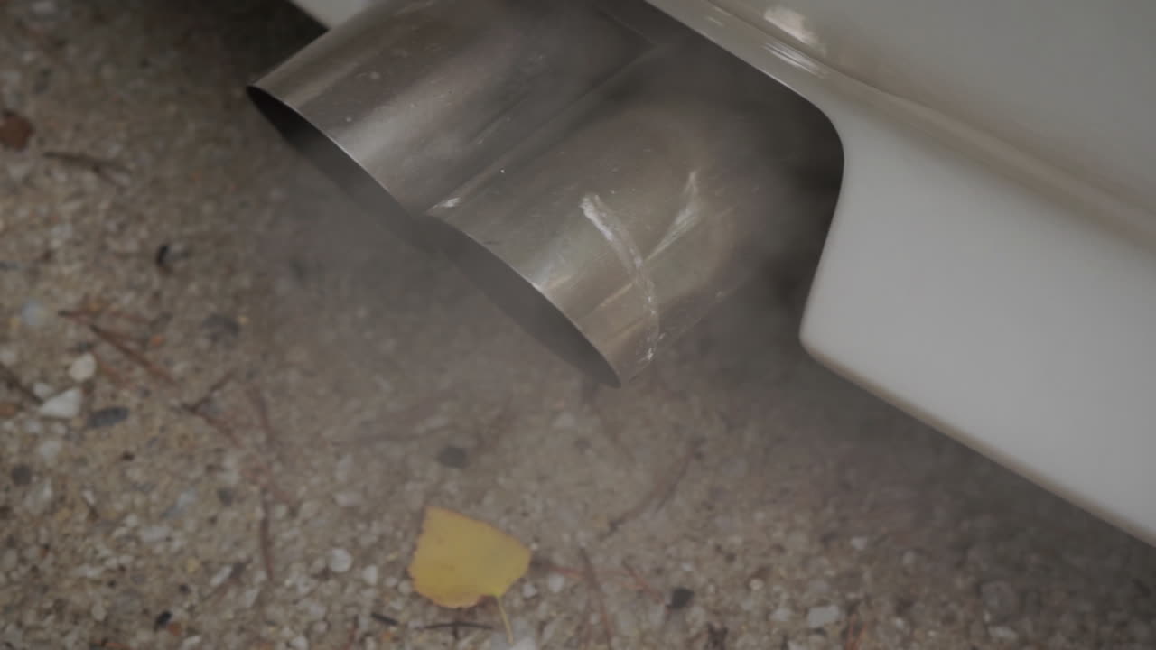 Double Exhaust of a White Car