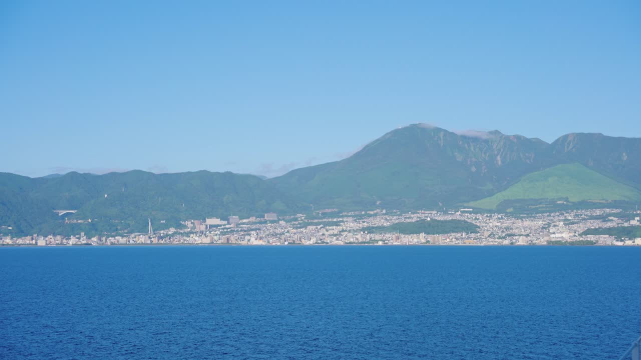Coastal Cityscape with Mountains