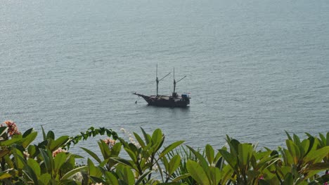 old wooden sail ship anchored in the ocean with tide passing by