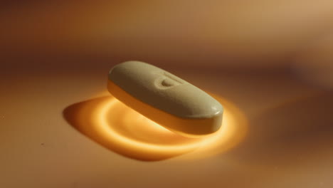 close-up of a single white oval pill with a 'b' imprint