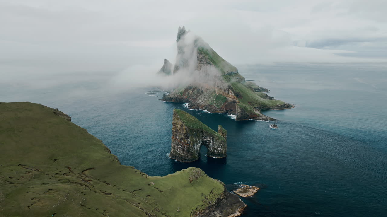 Dramatic Sea Stacks and Cliffs of the Faroe Islands Shrouded in Mist