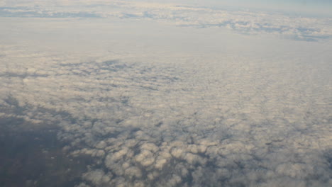 aerial view of clouds out of plane window shot in 4k high resolution