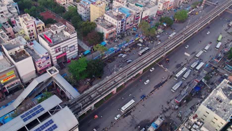 hyderabad metro station with railway track, road and vehicles at day time, bird eye view, slight zoom in, drone shot, 4k.