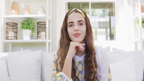 Portrait-of-happy-biracial-woman-spending-time-at-home-and-having-video-call