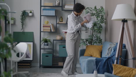 woman cleaning and organizing living room