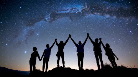 silhouettes of people united under a starry night sky