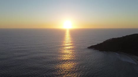 Breathtaking aerial footage of Noosa National Park at sunrise, showcasing the serene coastal landscape and warm morning light.