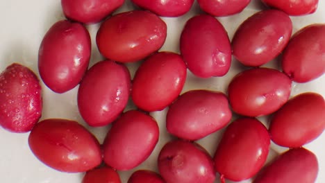 pickled round green olives from greece as background, top view. high quality 4k footage