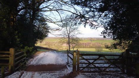 a farm track leading through a farm gate opens up to spectacular views of the worcestershire countryside, england, uk on a cold winters day