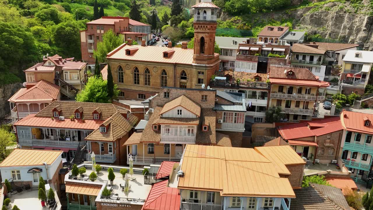 A charming drone viddeo highlighting the colorful rooftops, churches, and narrow streets of Tbilisi’s historic center with its famous clock tower