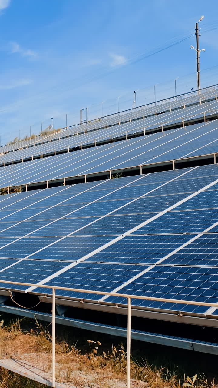 Photovoltaic panels under blue sky. Modern sunny batteries get clean alternative energy from the sun. Renewable source of energy. Vertical video