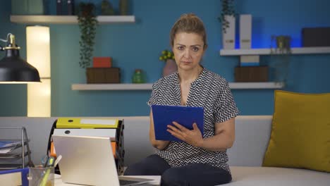 Home-office-worker-woman-looking-dull-at-camera.