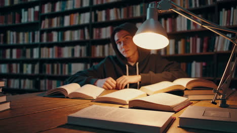 student studying in a library at night