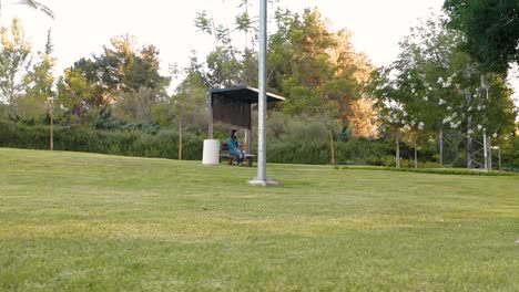 girl sits on a bench in the park