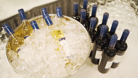 bottles of wine sitting in a bowl of ice