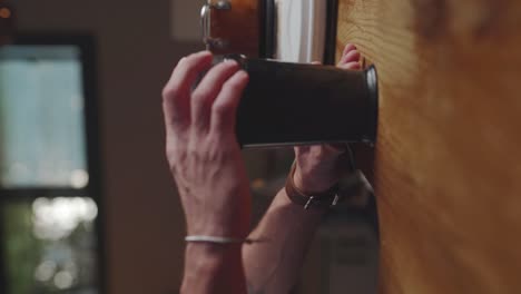 Closeup-of-hands-loading-small-blender-on-countertop