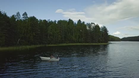 feminist free woman on a boat with paddle and relaxing man in a hat, aerial rotating around