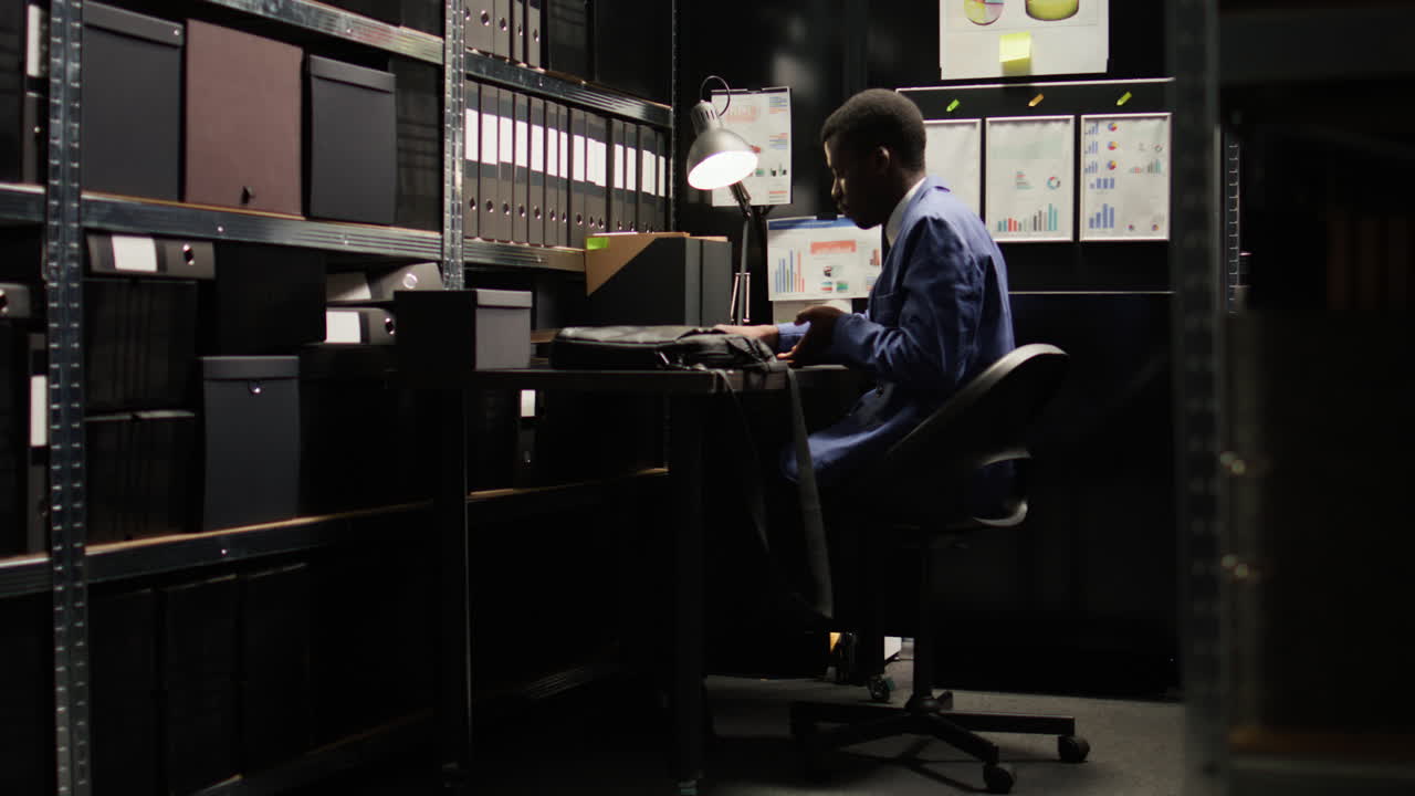 Man working in a dark office archive
