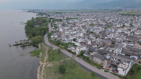 drone footage of a small village settlement next to the haishe ecological park in dali, yunnan province in china