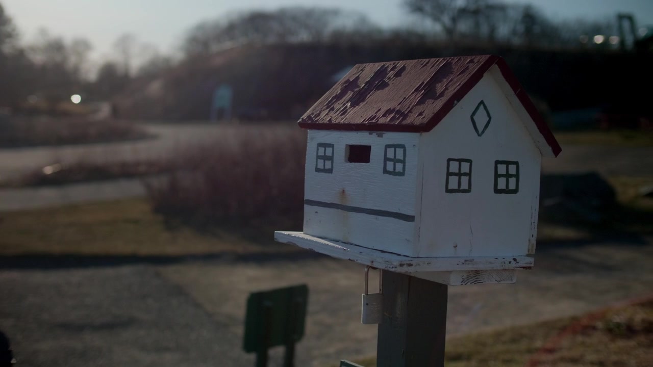 Closeup Of House-shaped Mailbox Outdoor In Portland, Maine, USA. handheld shot