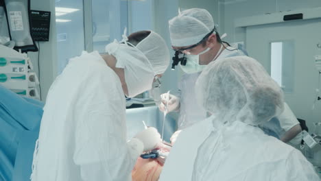 surgeons attach grafts in operating room. experienced surgical team performs complicated surgery on patient heart to divert blood supply in hospital