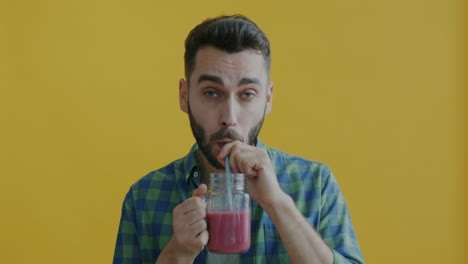 man drinking smoothie