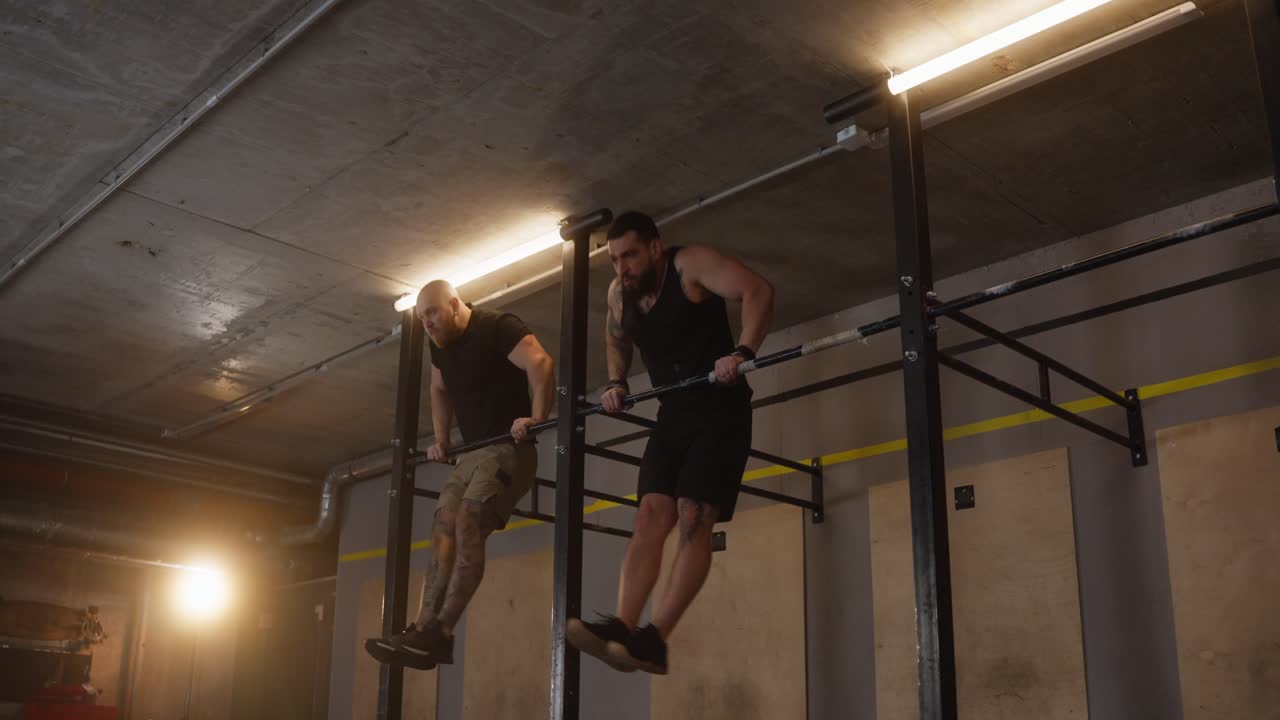 Men doing pull-ups in the gym