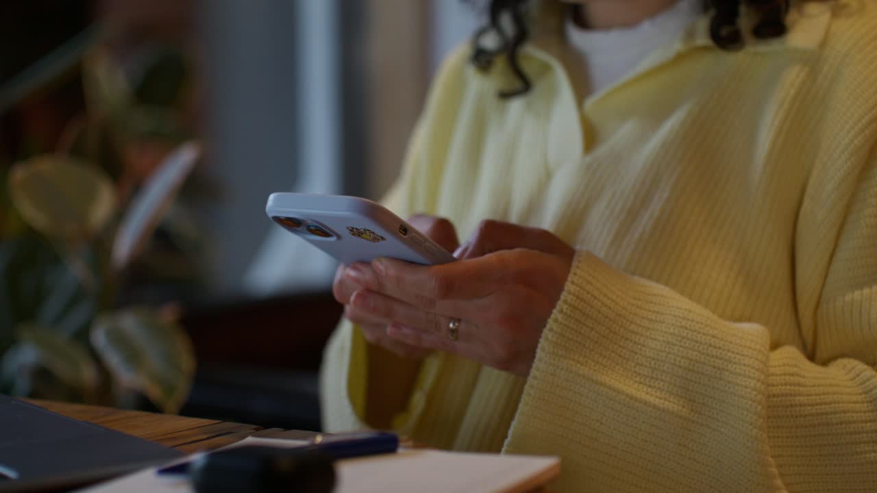 Woman using smartphone at a cafe