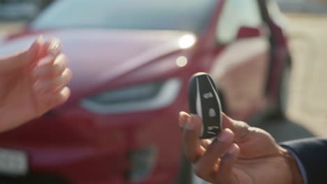 handing over a tesla car key