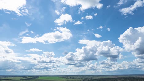 4k time lapse of moving clouds over horizon, green hilly area