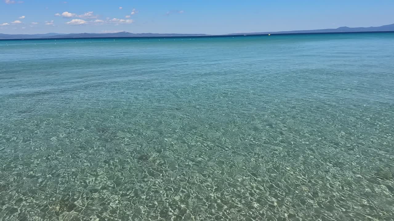 Stunning beach scene in Halkidiki, Greece, with elegant sunbeds facing the crystal-clear turquoise sea. A perfect summer escape in the heart of the Aegean.