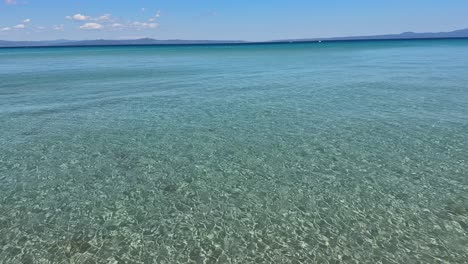 Stunning beach scene in Halkidiki, Greece, with elegant sunbeds facing the crystal-clear turquoise sea. A perfect summer escape in the heart of the Aegean.