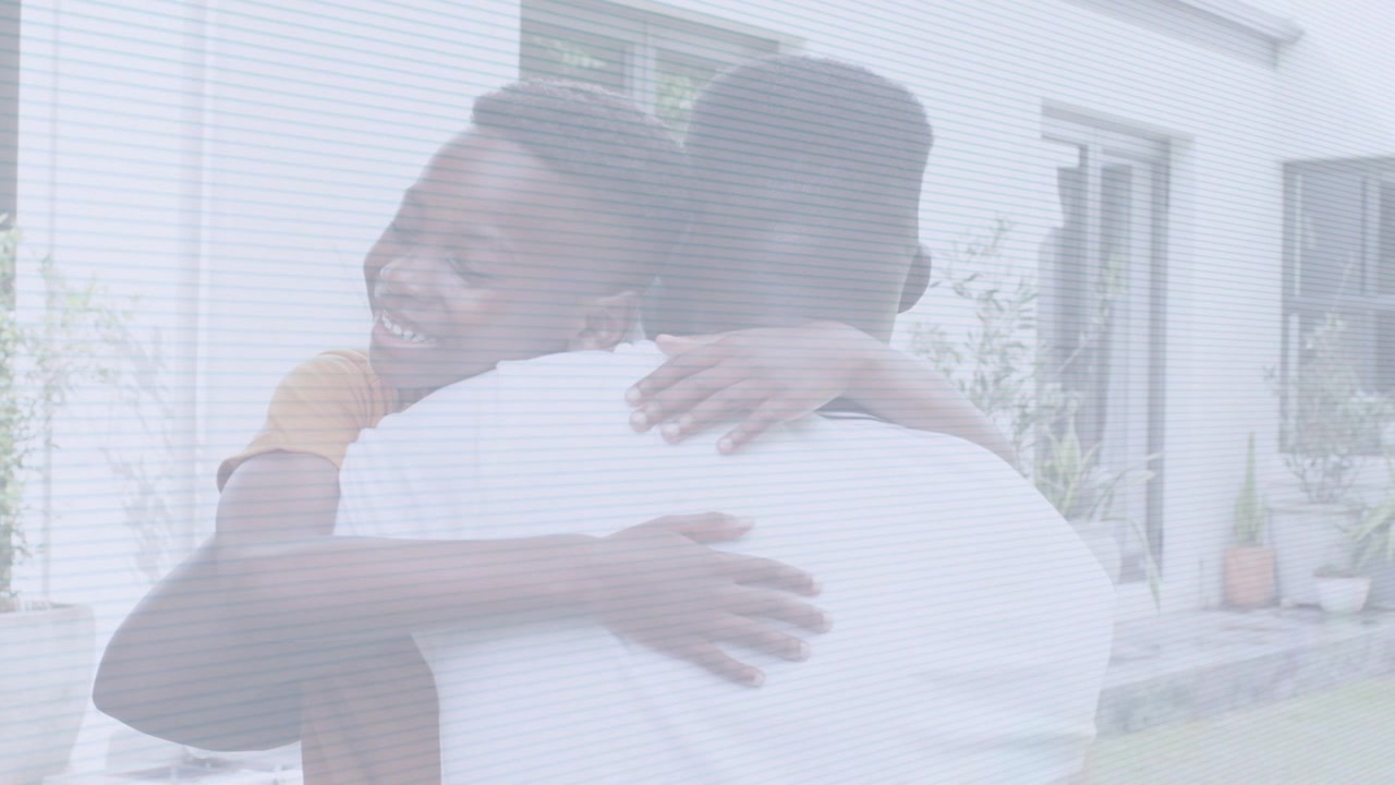Child wrapping arms around dad, dad holding child and smiling, bonding for health ad outside house