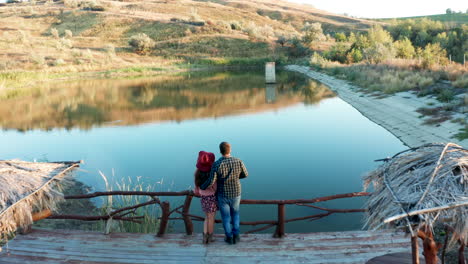 Couple-on-a-pontoon-bridge-in-a-vacation-in-rural-area