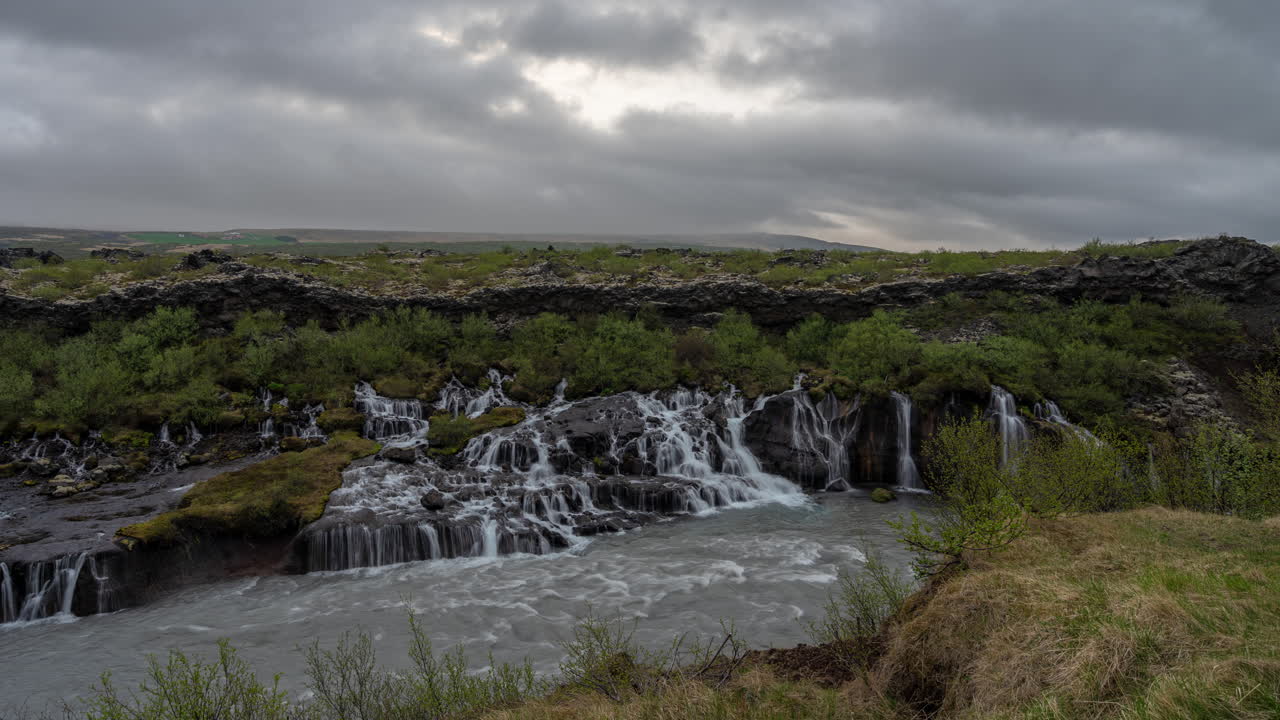 Hraunfossar Waterfalls Iceland, Timelapse. Dramatic Sky Above Falls in Lava Field and Canyon