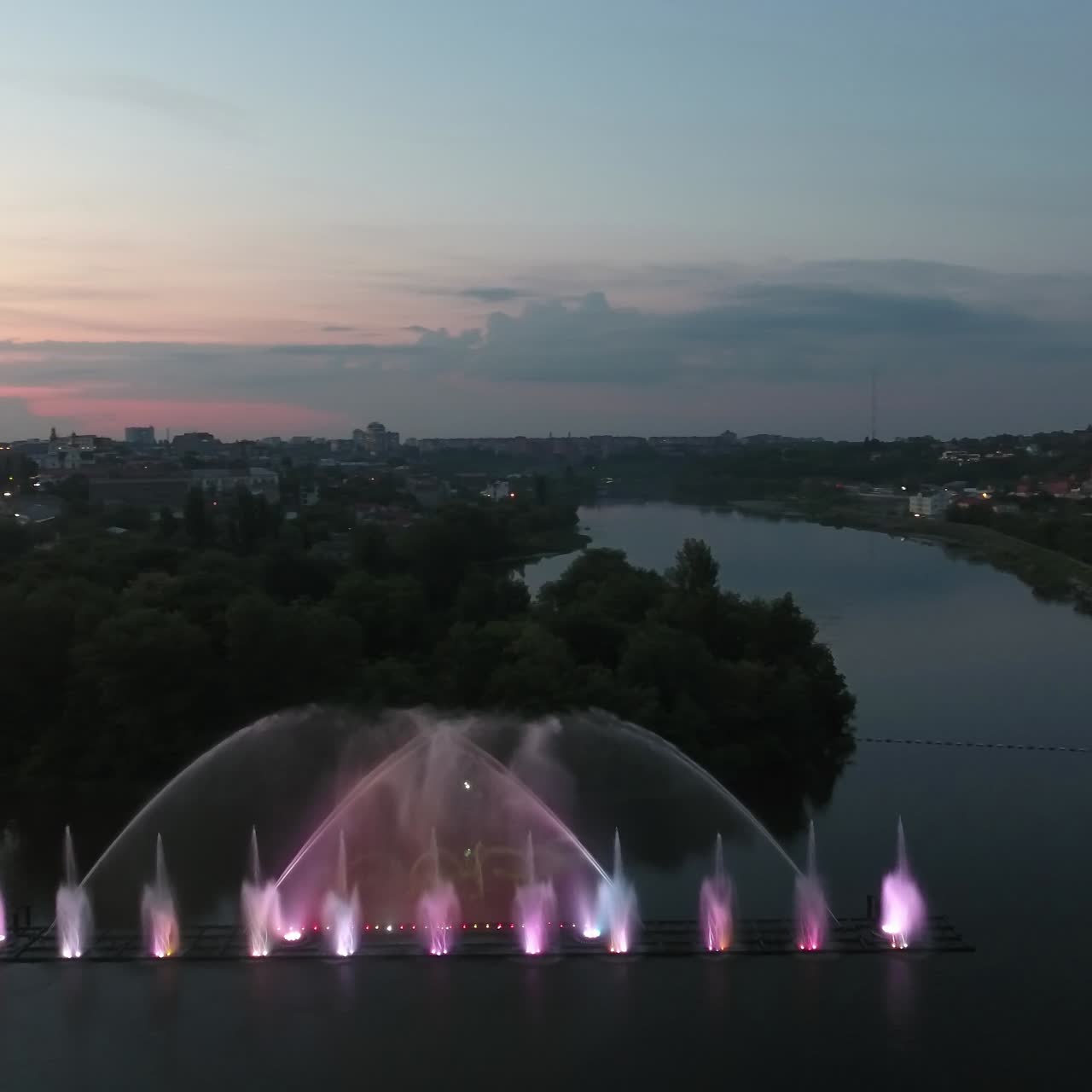 Musical Fountain Show. Aerial shot of the beautiful fountain show with reflection on water at night