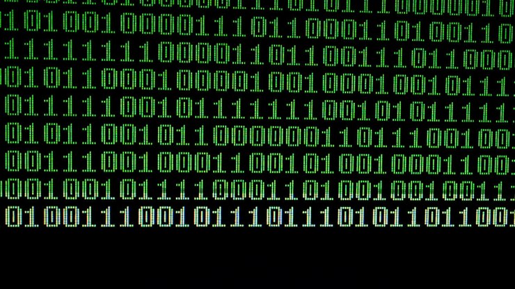 Binary code on the monitor screen. Shooting of a binary code, background