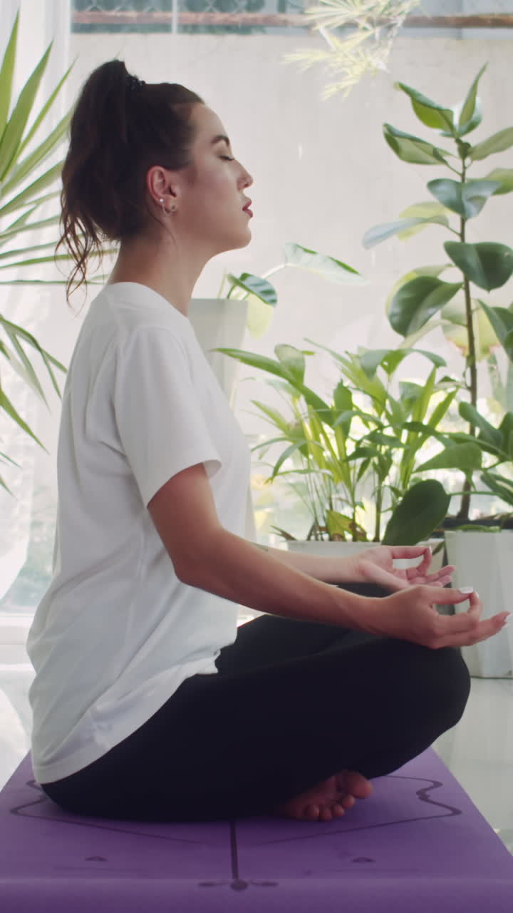 Girl Meditating on Floor in Lotus Pose
