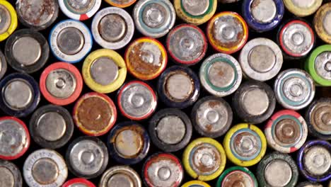 old used discarded aa cells and other electric batteries from old used discarded aa cells and other electric batteries from different manufacturers waste waste collection and recycling high risk they rotate on the turntable around their axis movement