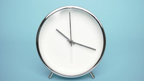the alarm clock is isolated on a blue background.