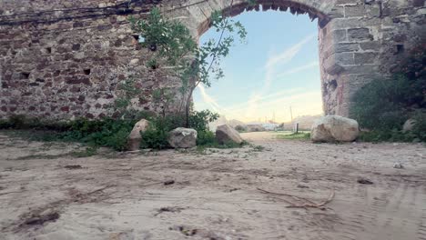 a revolving perspective of an ancient stone gate incorporated into the wall, embodying the essence of medieval architecture and temple design
