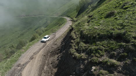 aerial - car driving down the tskhratskaro pass, georgia, forward shot