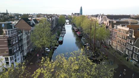 narrow canals of amsterdam, netherlands - cinematic establishing drone shot