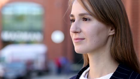 pensive serious woman standing outside office and looking around