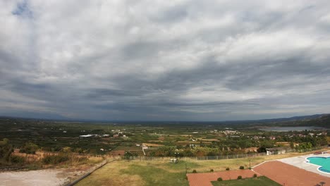 Time-lapse-with-clouds-moving-fast-above-the-green-fields-of-northern-Greece