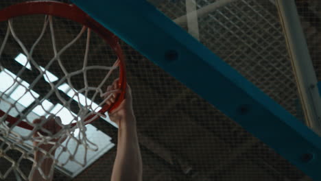 high school team basketball player practicing dunks indoors. 4k uhd