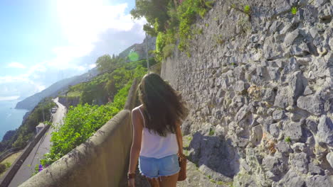 two women walking on a scenic path in italy