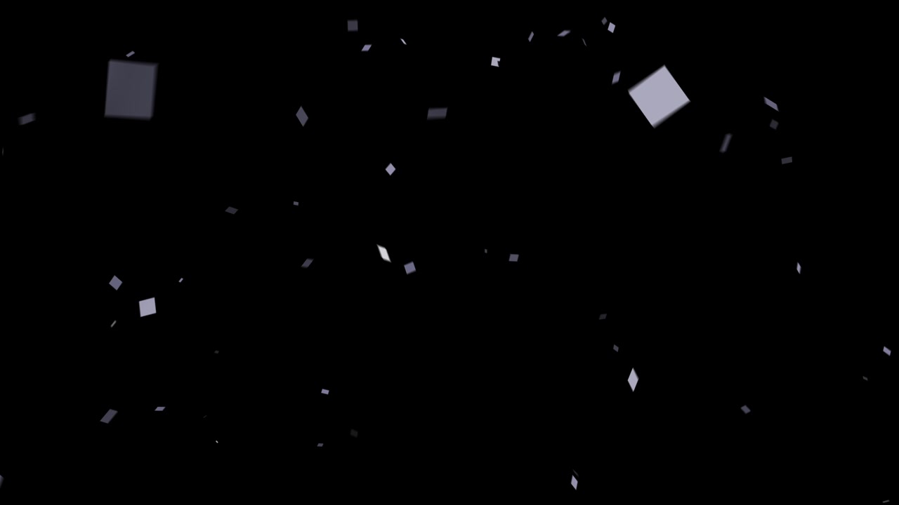 An elegant explosion of shiny silver confetti falls gracefully against an isolated black background. For weddings, New Year's, or luxury events