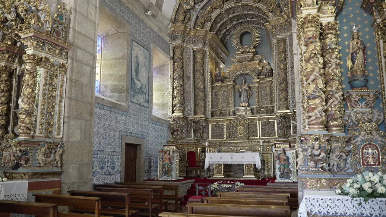 golden baroque church interior with detailed altar and wooden benches